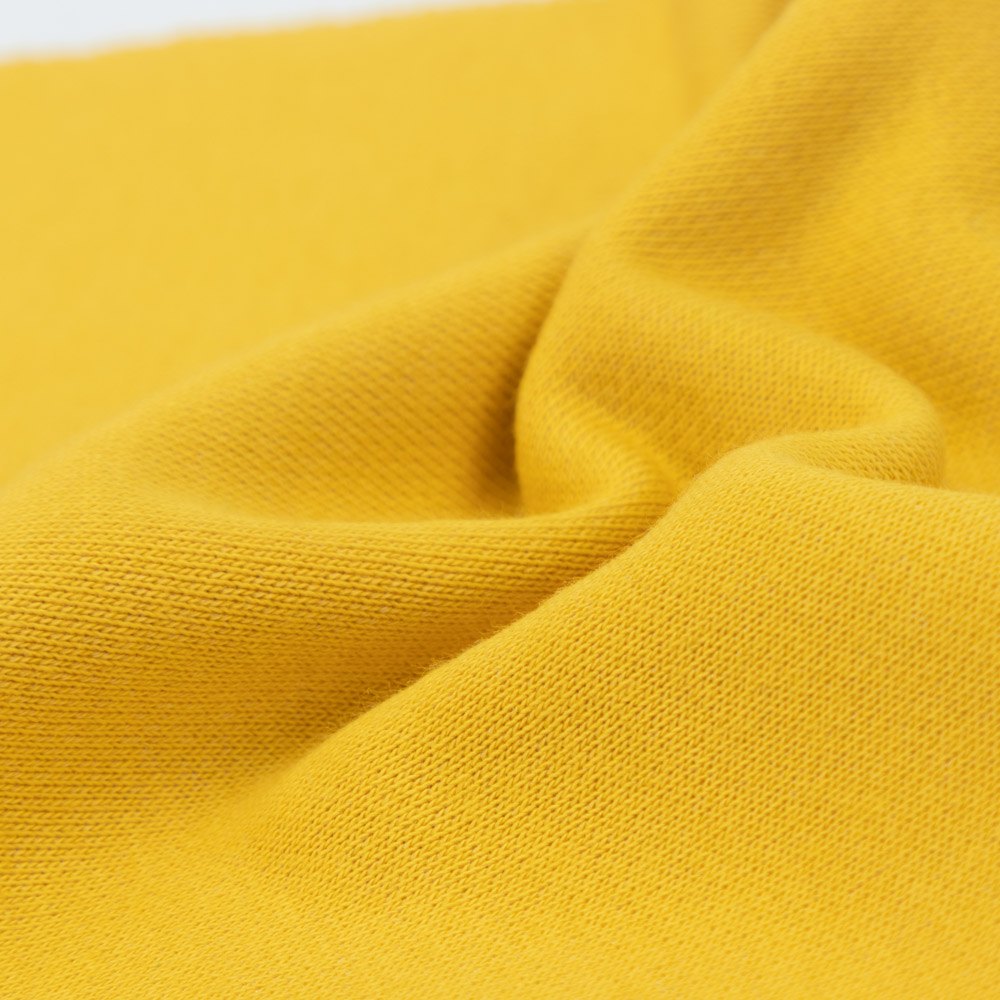 Qu'est-ce que le tissu éponge tricoté en coton et élasthanne et à quoi sert-il ?
